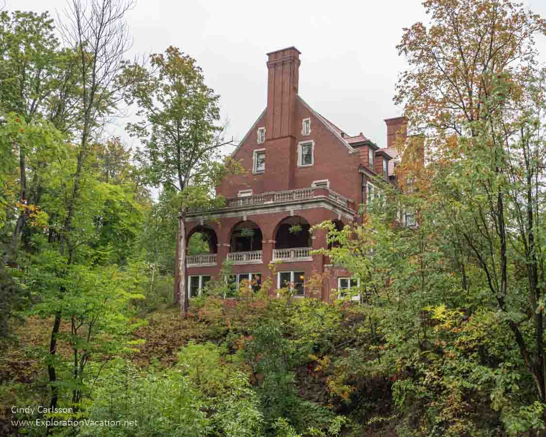 photo of the exterior of Glensheen, a large brick mansion in a wooded area of Duluth Minnesota &copy; Cindy Carlsson at ExplorationVacation.net