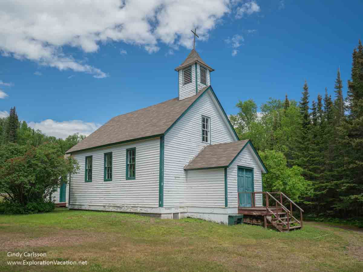 photo of the exterior of St Francis Xavier Church Chippewa City on a sunny summer day in Grand Marais Minnesota &copy; Cindy Carlsson at ExplorationVacation