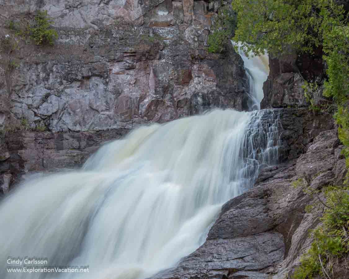 Long-exposure photo of a two-tier waterfall at the Caribou Falls State Wayside on Minnesota&rsquo;s North Shore &copy; Cindy Carlsson at ExplorationVacation.net