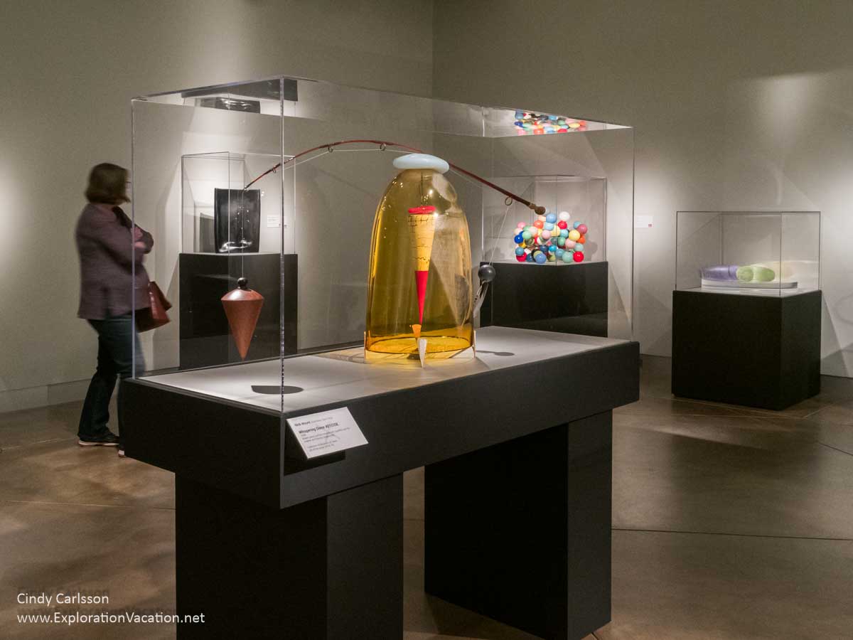 Photo of a woman looking at glass art, including &ldquo;Whispering Dome #010208&rdquo; by Australian artist Nick Mount, at the Museum of Glass in Tacoma, Washington &copy; Cindy Carlsson at ExplorationVacation.net