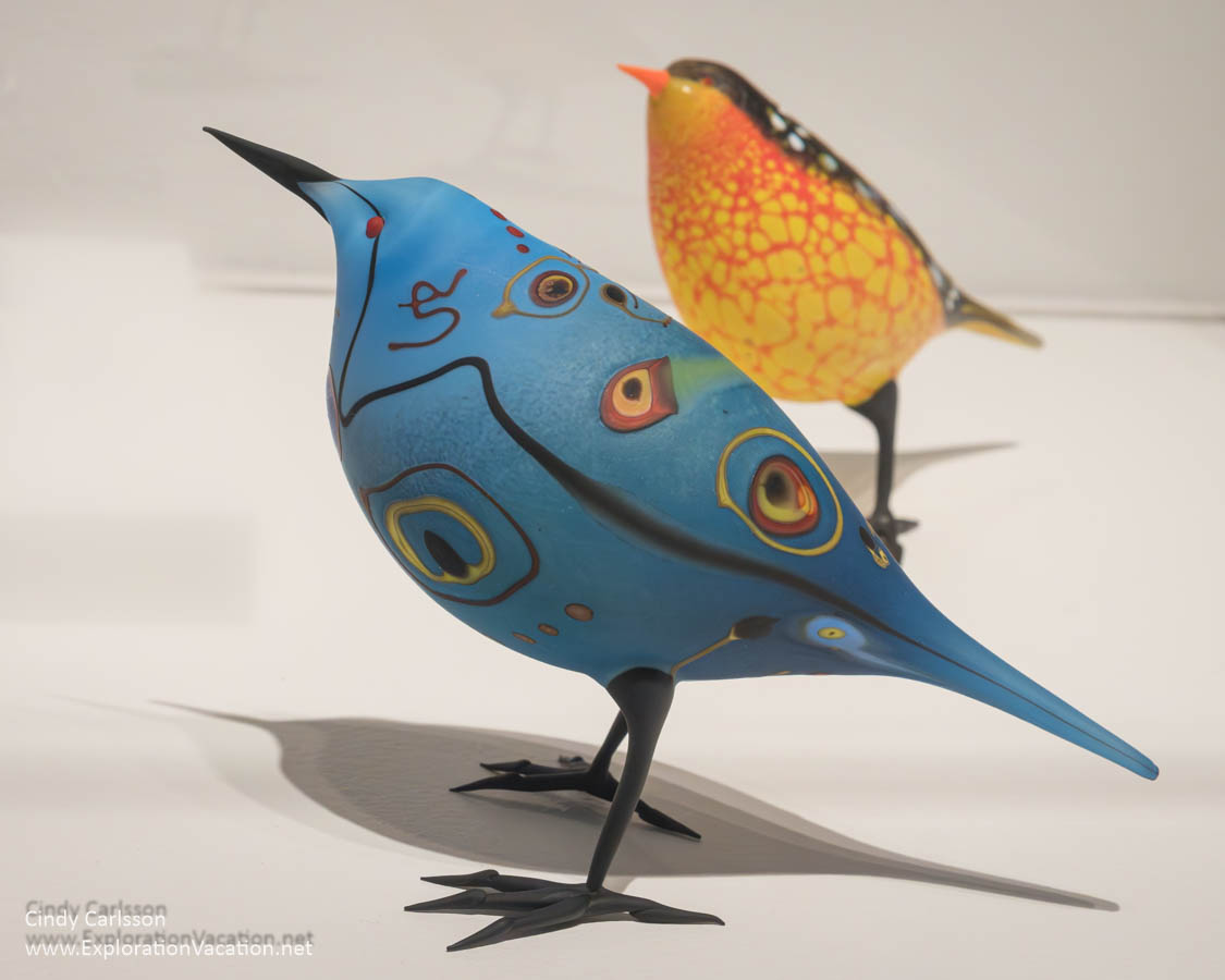 Photo of &ldquo;Abstract Bluebird&rdquo; and &ldquo;Black-Backed Yellow Warbler&rdquo; by Shane Fero at the Museum of Glass in Tacoma, Washington &copy; Cindy Carlsson at ExplorationVacation.net