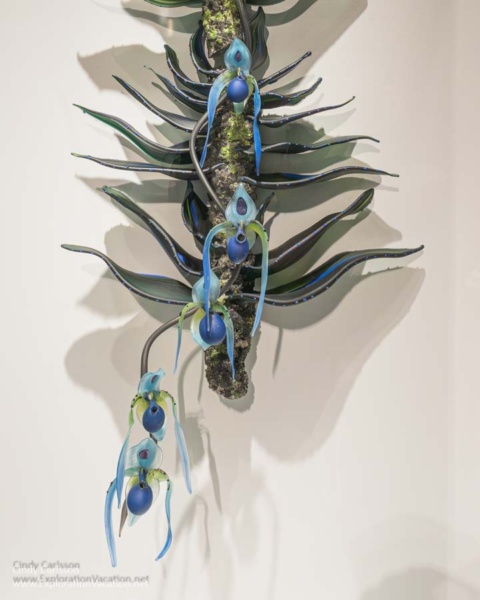 Photo of part of &ldquo;Blue Paphiopedilum Plant,&rdquo; a glass sculpture by Debora More &copy; Cindy Carlsson at ExplorationVacation.net