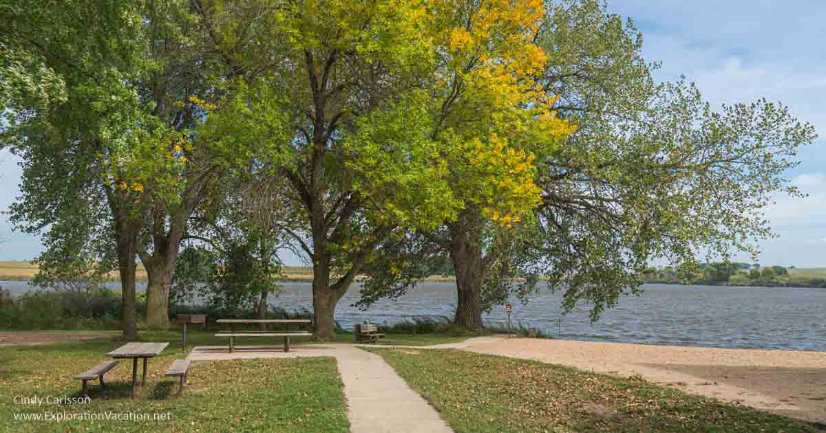 photo of a beach with trees and a picnic table at Split Rock Creek State Park in western Minnesota © Cindy Carlsson at ExplorationVacation.net