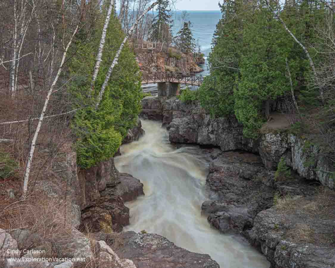 Photo of the Temperance River, paths and bridges, and Lake Superior from the Highway 61 Bridge over the river on Minnesota’s North Shore © Cindy Carlsson at ExplorationVacation.net