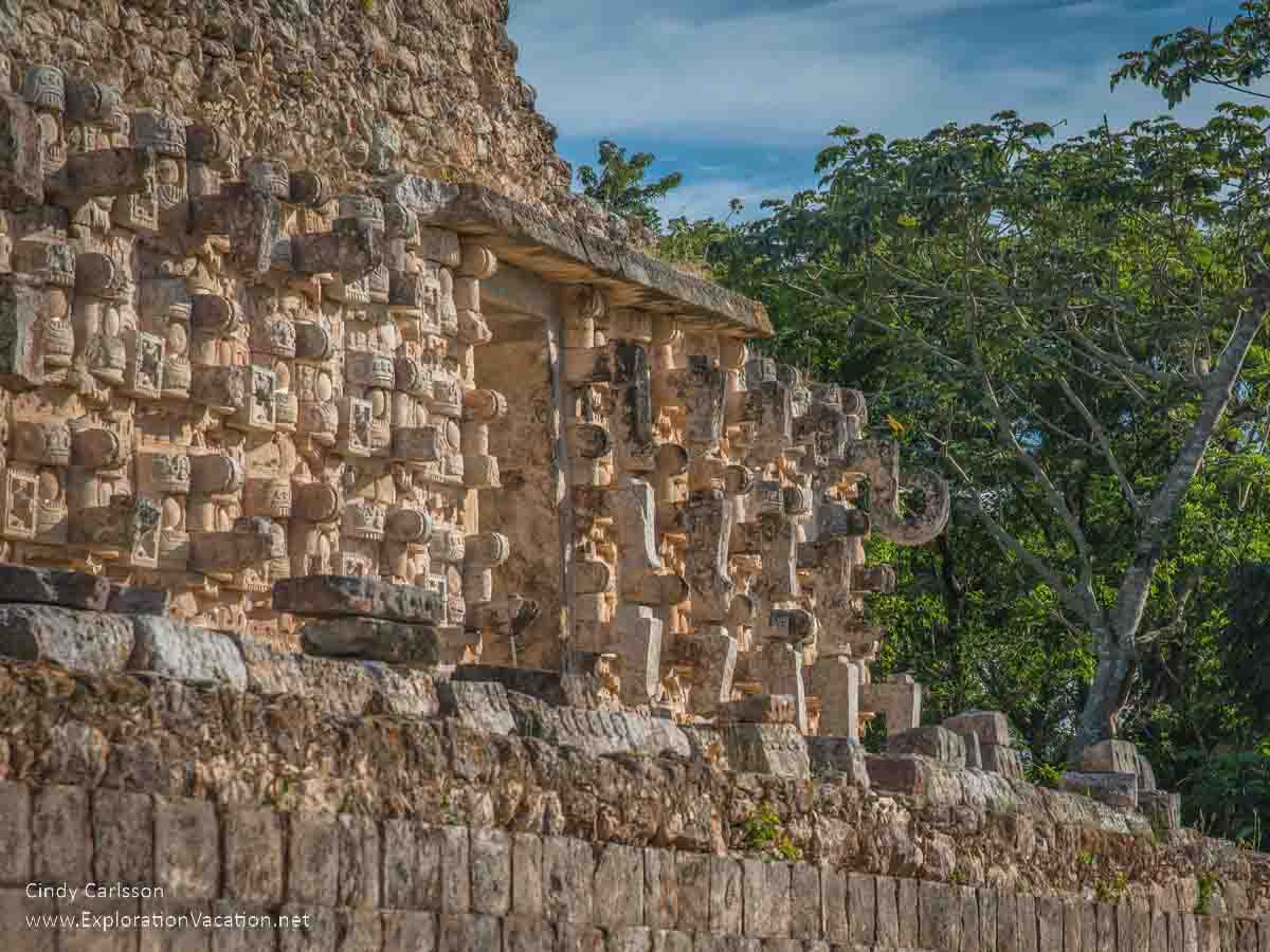 photo of a wall at the Mayan ruins of Kabah, Mexico, filled with faces of a rain god. It's part of the Pre-Hispanic Town of Uxmal World Heritage Site &copy; Cindy Carlsson at ExplorationVacation.net