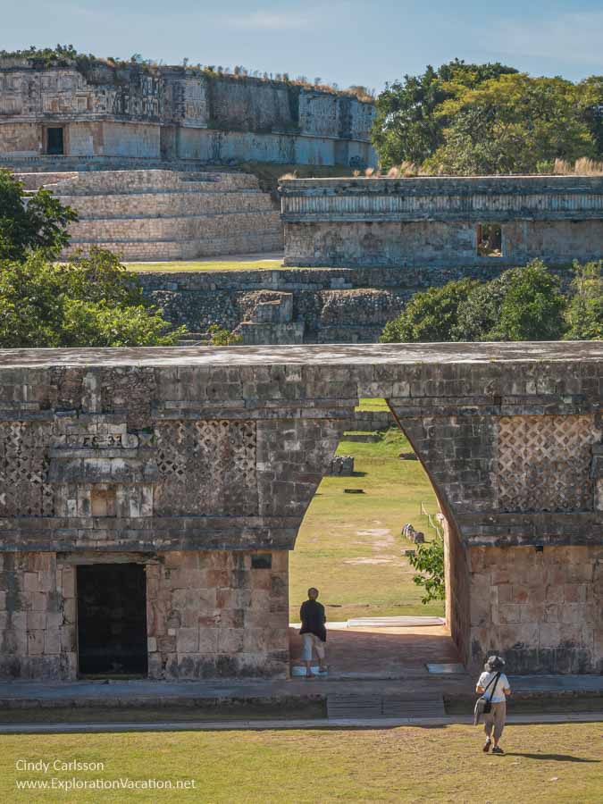 photo of people walking toward an arch at Uxmal, Mexico part of the Pre-Hispanic Town of Uxmal World Heritage Site &copy; Cindy Carlsson at ExplorationVacation.net