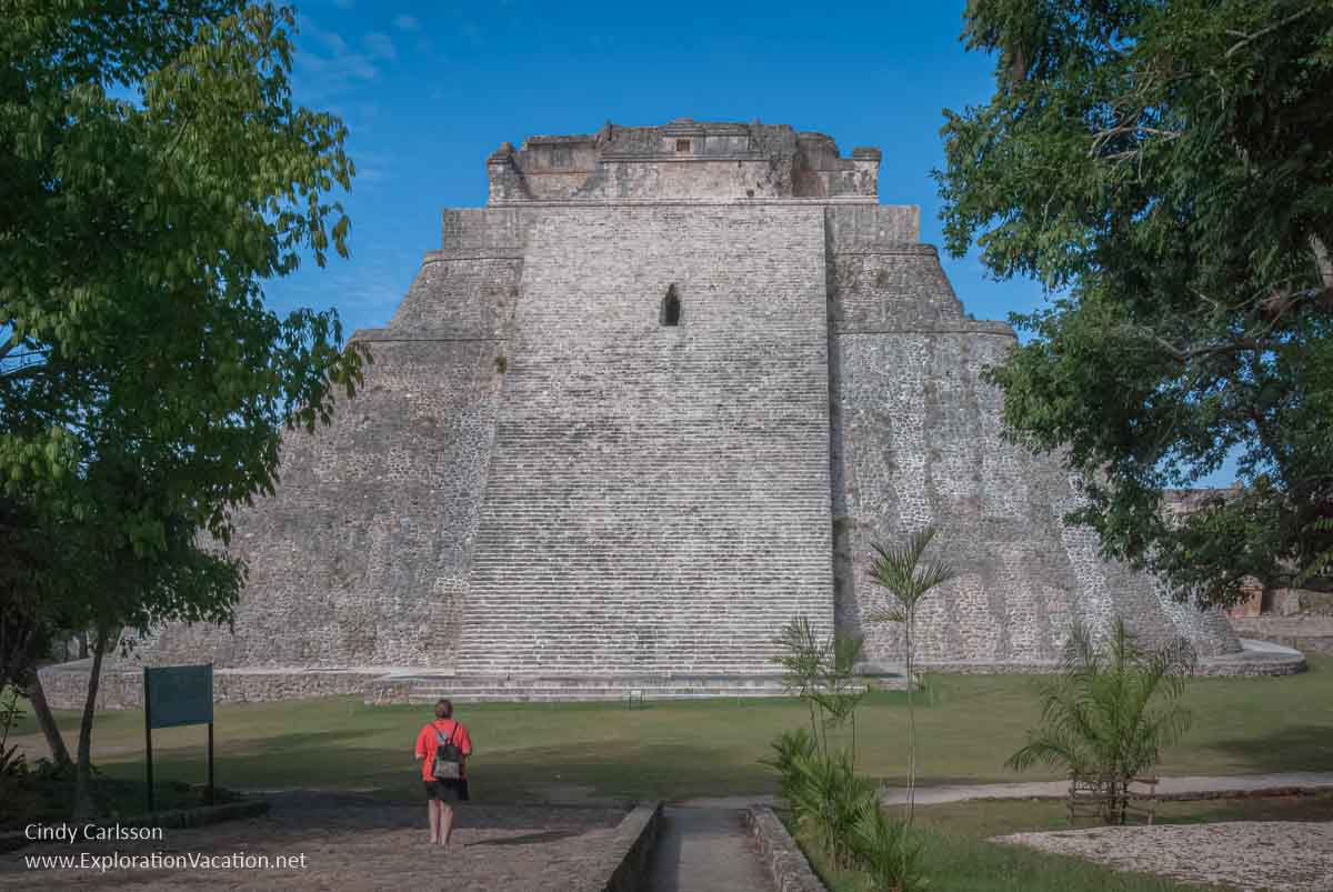 photo of a person standing in front of the Temple of the Magician (Soothsayer) in Uxmal, Mexico, part of the Pre-Hispanic Town of Uxmal World Heritage Site &copy; Cindy Carlsson at ExplorationVacation.net