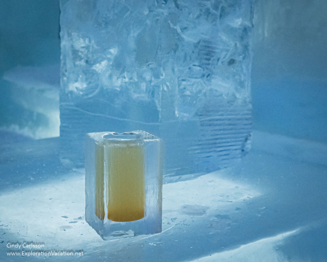 Photo of a square glass made from ice with a yellow cocktail in it sitting on an ice block in the Icebar at Icehotel 365 in Jukkasj&auml;rvi, Swedish S&aacute;pmi (Lapland) &copy; Cindy Carlsson ExplorationVacation.net