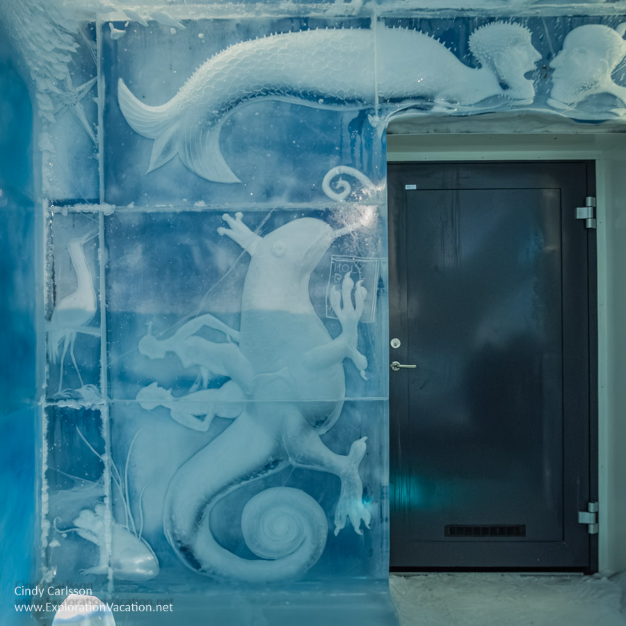 Photo of a door surrounded by imaginary undersea creatures carved into the walls of the Icehotel 365 suite Dreaming in a Dream in Jukkasj&auml;rvi, Swedish S&aacute;pmi (Lapland) &copy; Cindy Carlsson ExplorationVacation.net