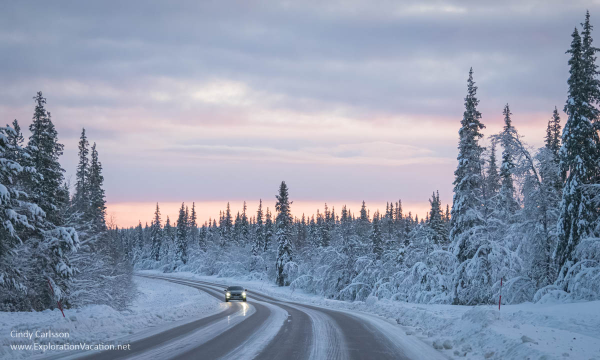 Winter photo of a road through Swedish Lapland.