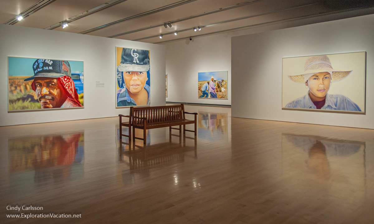 Photo of a gallery at the Phoenix Art Museum in 2014 with large portraits of migrant farmers by Don Coen &copy; Cindy Carlsson at ExplorationVacation.net