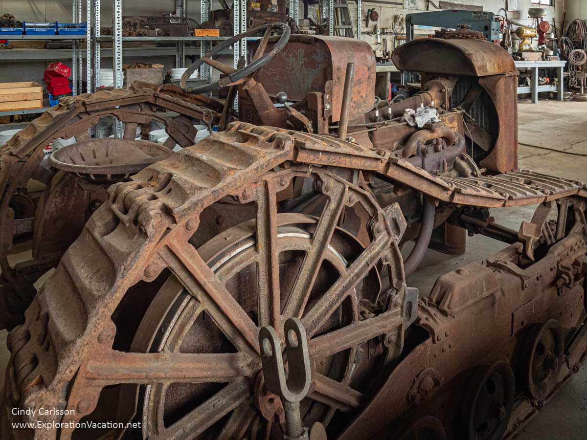Photo of a very rusty 1927 Fordson Tractor with after-market tracks displayed at the Bally Blacksmith Shop in Grand Marais, Minnesota &copy; Cindy Carlsson at ExplorationVacation.net
