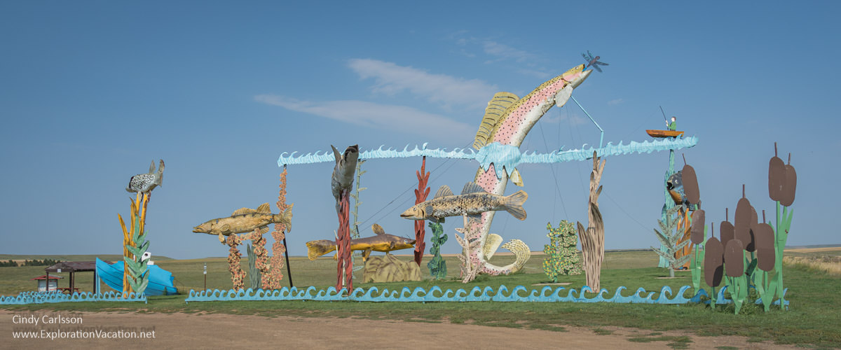 Photo of a scrap metal sculpture by Gary Greff that is collection of larger-than-life fish with a small boat and fisherman called Fisherman&rsquo;s Dream along the Enchanted Highway in western North Dakota &copy; Cindy Carlsson at ExplorationVacation.net