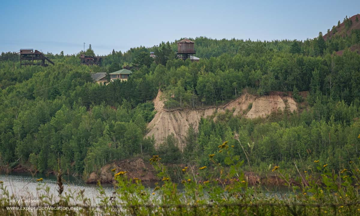 Photo of the Hill Annex Mine pit with historic buildings on the land above in Calumet, Minnesota © Cindy Carlsson ExplorationVacation.net