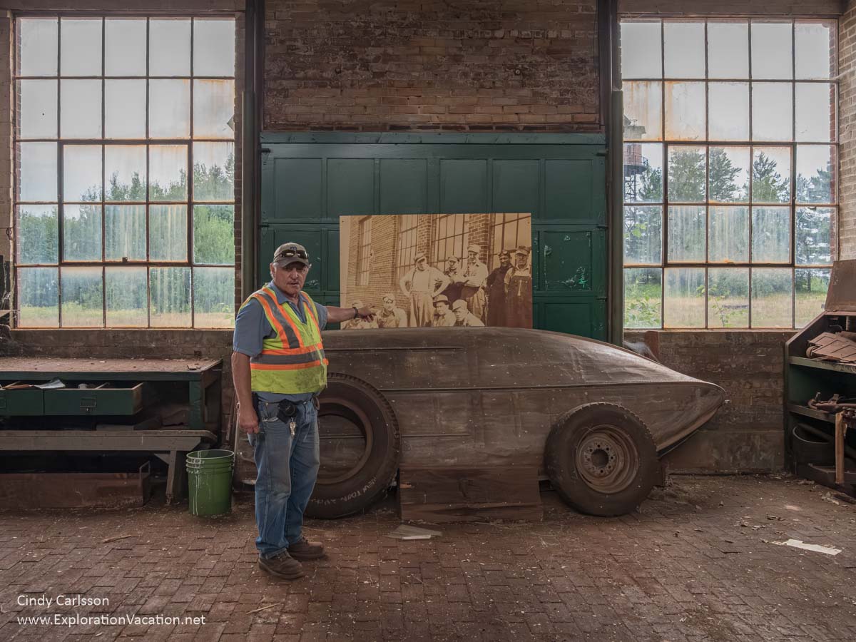 2018 photo of a park employee telling a story about a photo inside the Railroad Equipment Repair Garage at the former Hill Annex Mine State Park in Calumet, Minnesota. (Photo © Cindy Carlsson - ExplorationVacation.net)