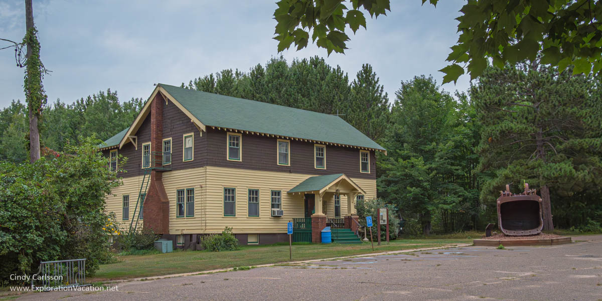 photo of the museum at the former Hill Annex Mine State Park, formerly the mine's community clubhouse and a shovel from a piece of old mining equipment in Calumet, Minnesota © Cindy Carlsson ExplorationVacation.net