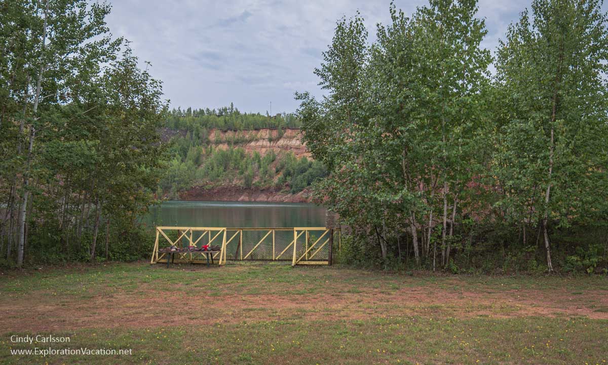 Photo of a fence blocking access to the lake filling the Hill Annex Mine pit in Calumet, Minnesota © Cindy Carlsson ExplorationVacation.net