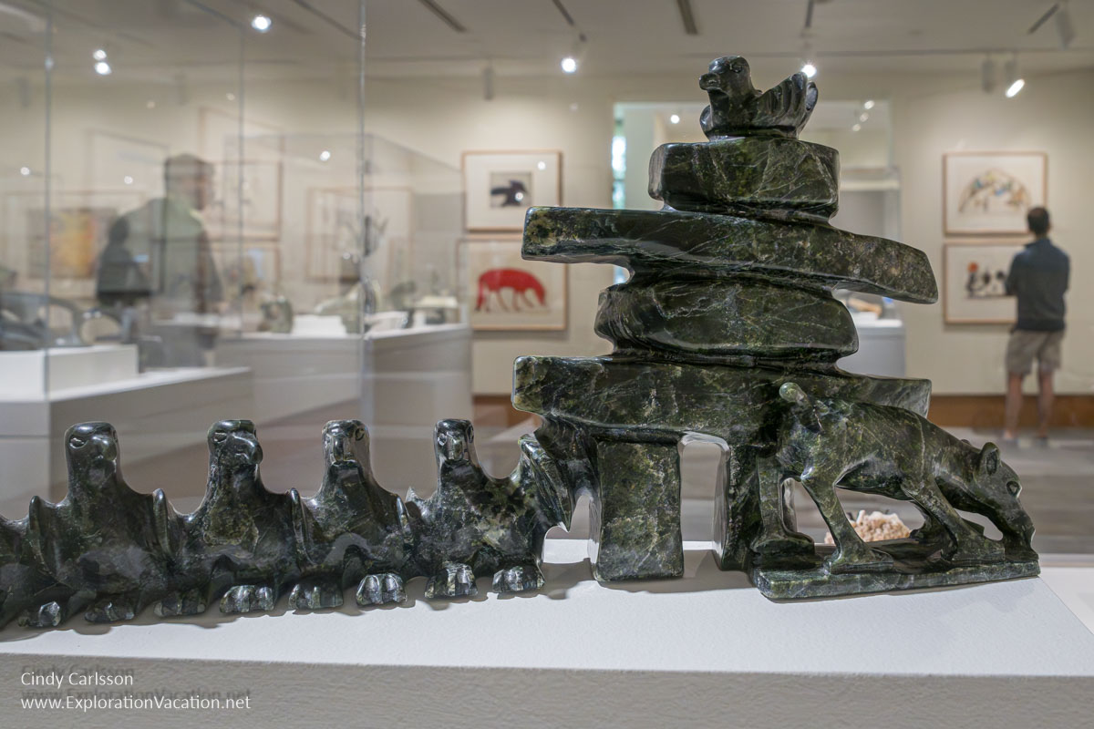 Photo of a serpentine sculpture of an inukshuk with birds and caribou by Pavinak Petaulassie on display at the Dennos Museum Center at Northwestern Michigan College in Traverse City, Michigan. (Photo © Cindy Carlsson on ExplorationVacation.net)