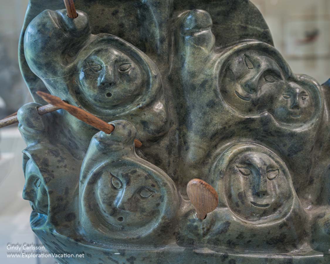 Photo of a few of the people on a migration boat carving by Joe Talirunili at the Dennos Museum Center at Northwestern Michigan College in Traverse City, Michigan. (Photo © Cindy Carlsson on ExplorationVacation.net)