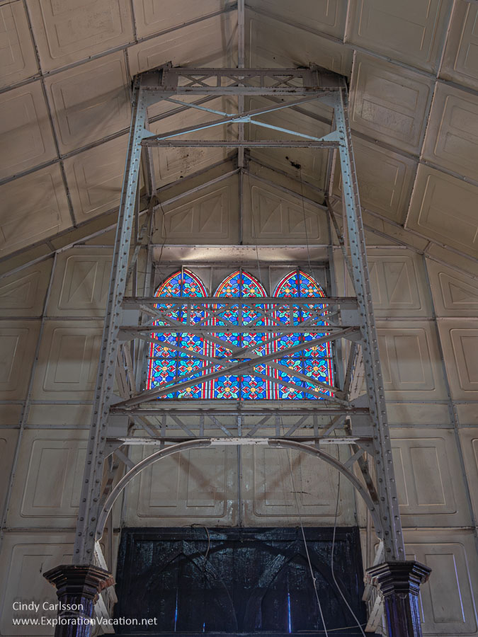 Photo of the metal supports for the bell tower that rise up through the ceiling/roof on either side of the entrance to the Church of Santa Barbara in Santa Rosalia, Baja California Sur, Mexico. (Photo &copy; Cindy Carlsson - ExplorationVacation.net)