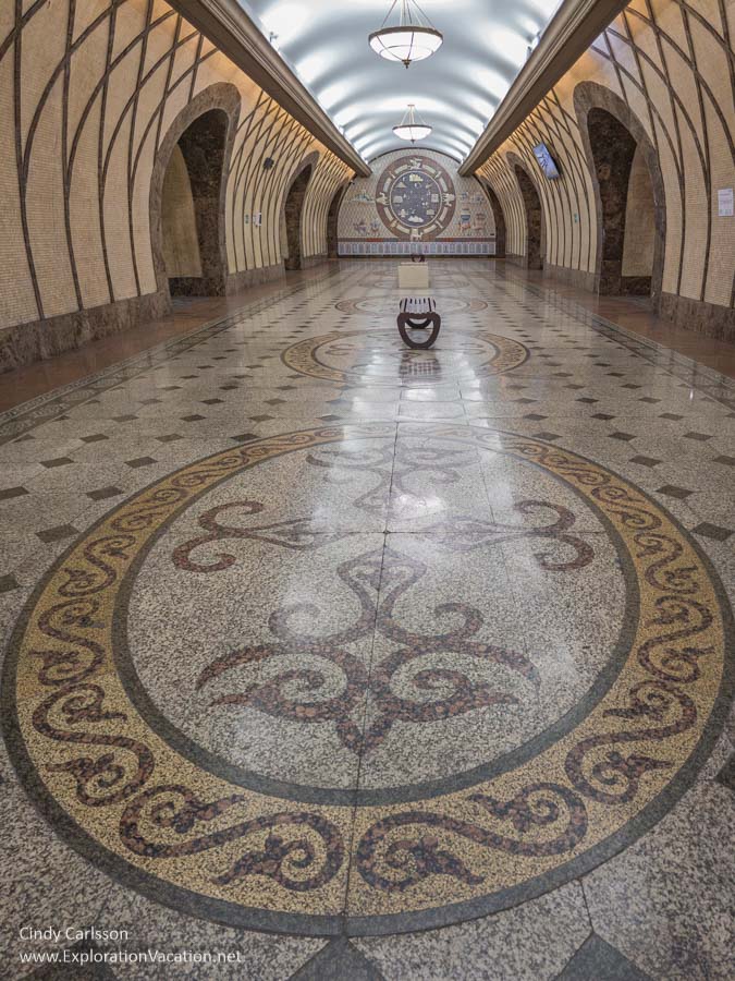 Mosaic floors and patterned walls in the center hall of a metro station.