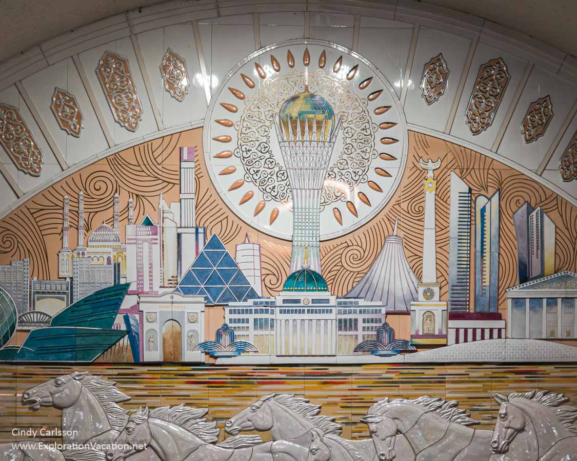 A tile mural depicting sunrise over the steppes with a herd of running horses set against the capital Astana.