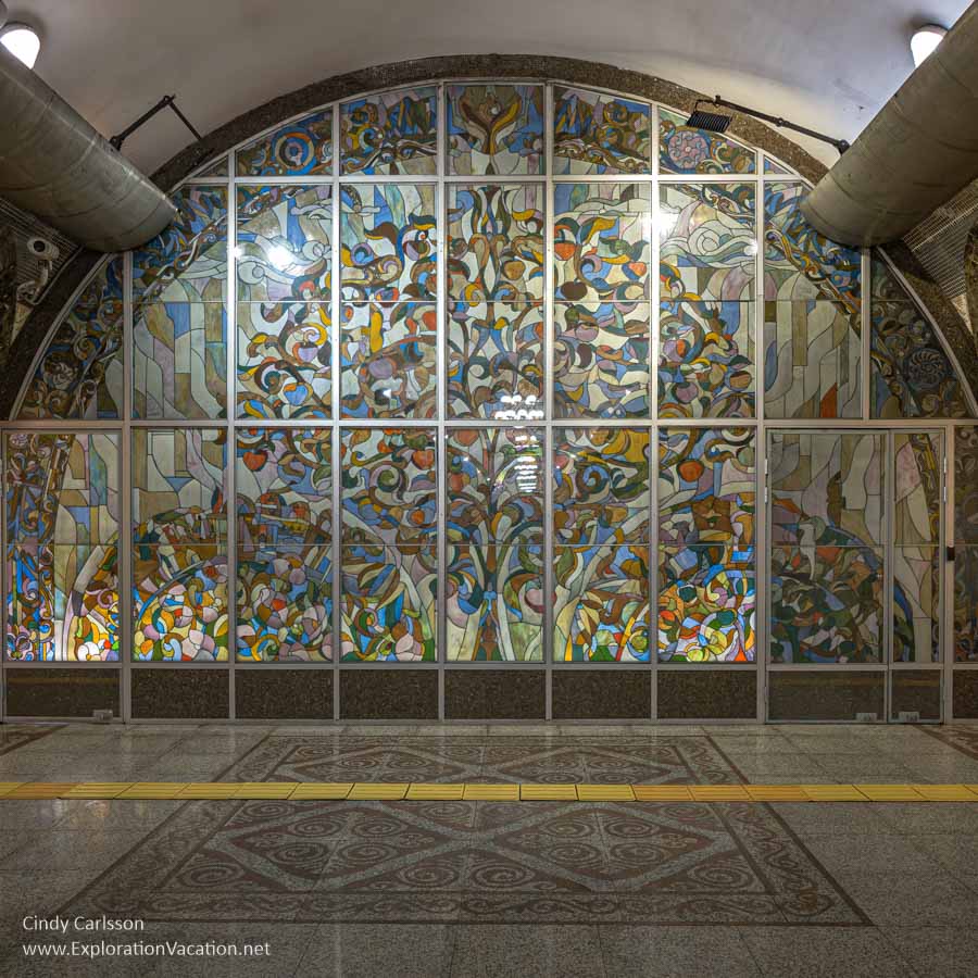 A glass mural of an apple tree at one end of a station on the Almaty metro system. 
