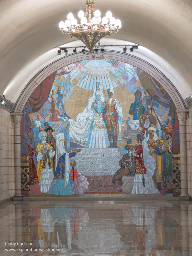 A colorful mural of a festive occasion in the Auezov Theater metro station in Almaty.