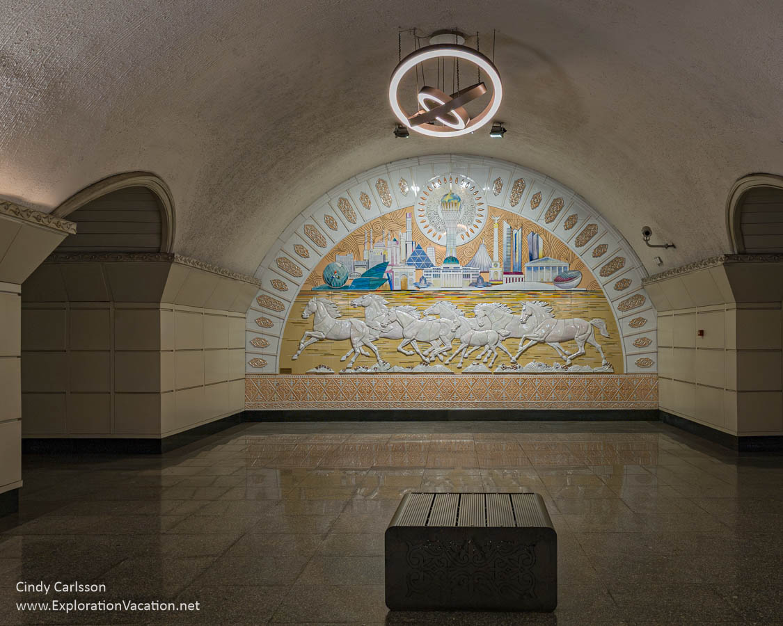 Photo of the main hall at the Saryarka / Сарыарқа Station with a ceramic mural depicting the Saryarka steppe, the capital Astana, and a herd of horses in the Saryarka metro station in Almaty, Kazakhstan. (Photo &copy; Cindy Carlsson on ExplorationVacation.net)