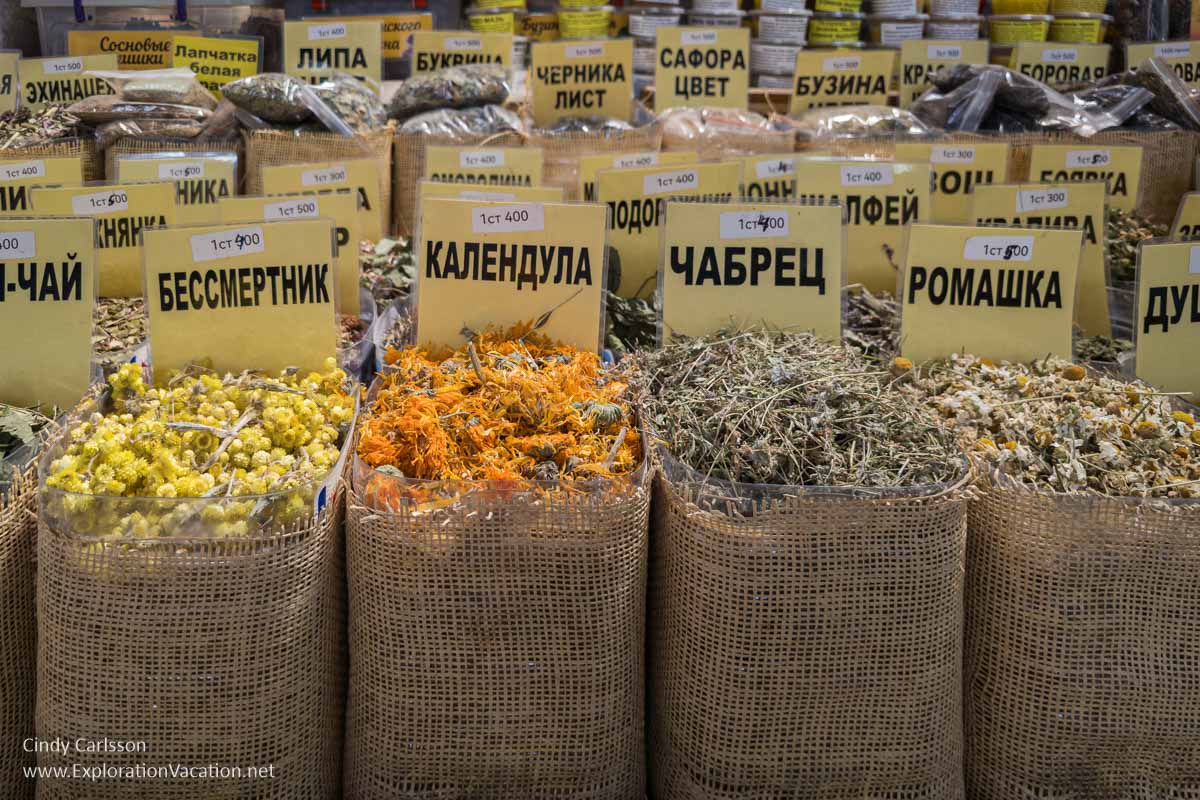 Small burlap bags filled with small dried flowers and herbs for making homemade herbal tea for sale in a market in Almaty.
