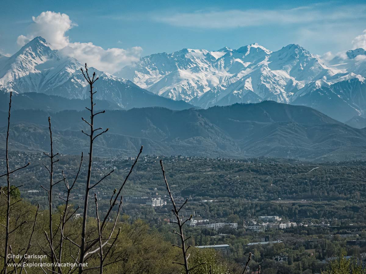 Snow-covered mountain peaks in the near distance as seen from Kok Tobe Hill.
