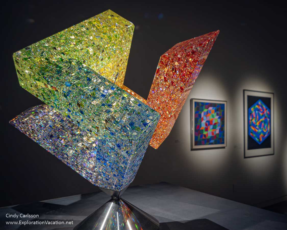 “Joseph Ribbon,” a colorful geometric glass sculpture by American artist Jon Kuhn and two pieces by Hungarian artist Victor Vasarely.