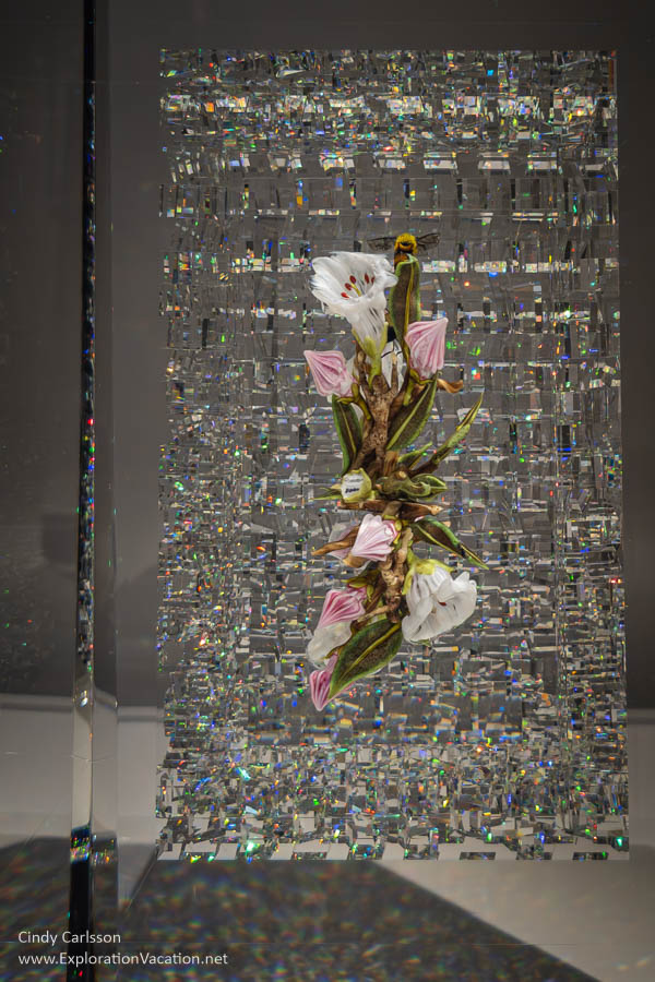 Glass flowers by Paul Stankard embedded in iridescent textured art glass by Jon Kuhn.