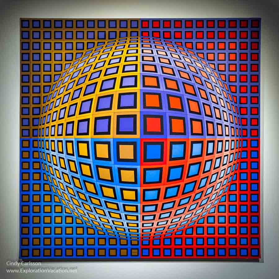 Photo of a pop art acrylic painting of squares that form a 3d circle by Victor Vasarely.