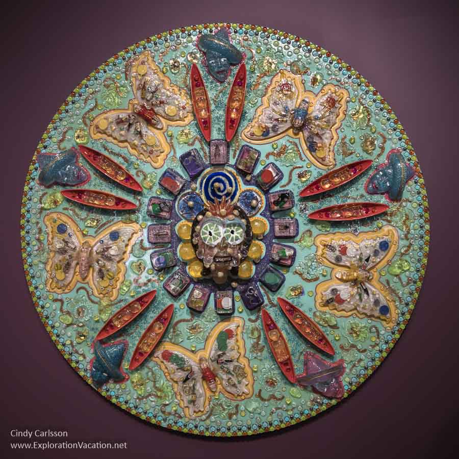 A mixed-media piece with butterflies, seed pods, and other images called Llorando de Felicidad (Crying with Happiness) by Einar and Jamex de la Torrea.