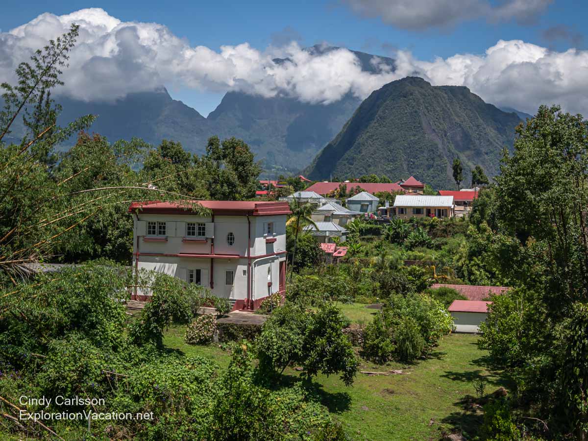 Houses at the edge of a small town along mountains.