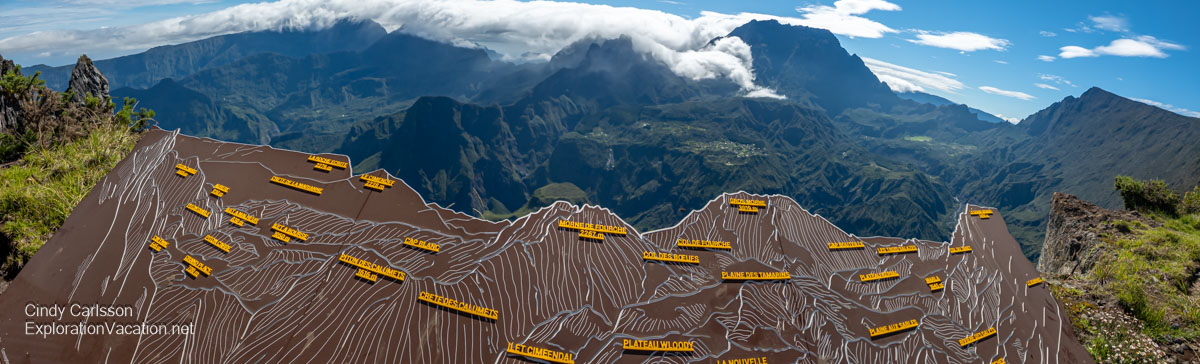 Sign at the Ma&iuml;do Overlook with mountain peaks pictured and named and the actual mountains clearly visible in the background.