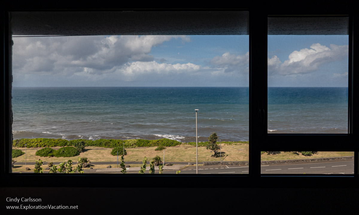 View of a park and the sea seen through windows.