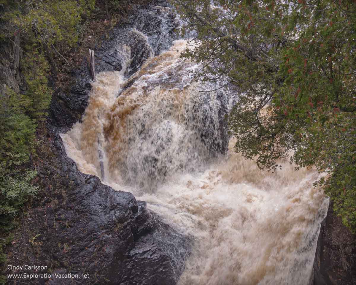 Part of a raging waterfall that splits in two.