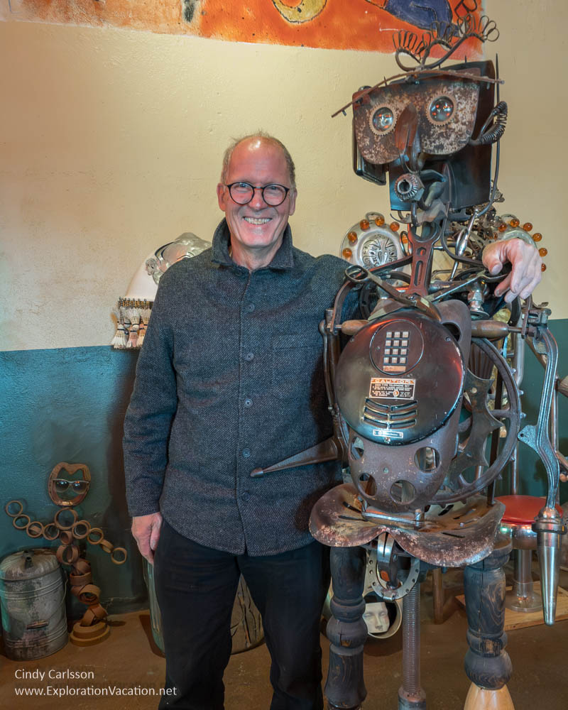 Allen Christian posing with one of his humanoid creations.