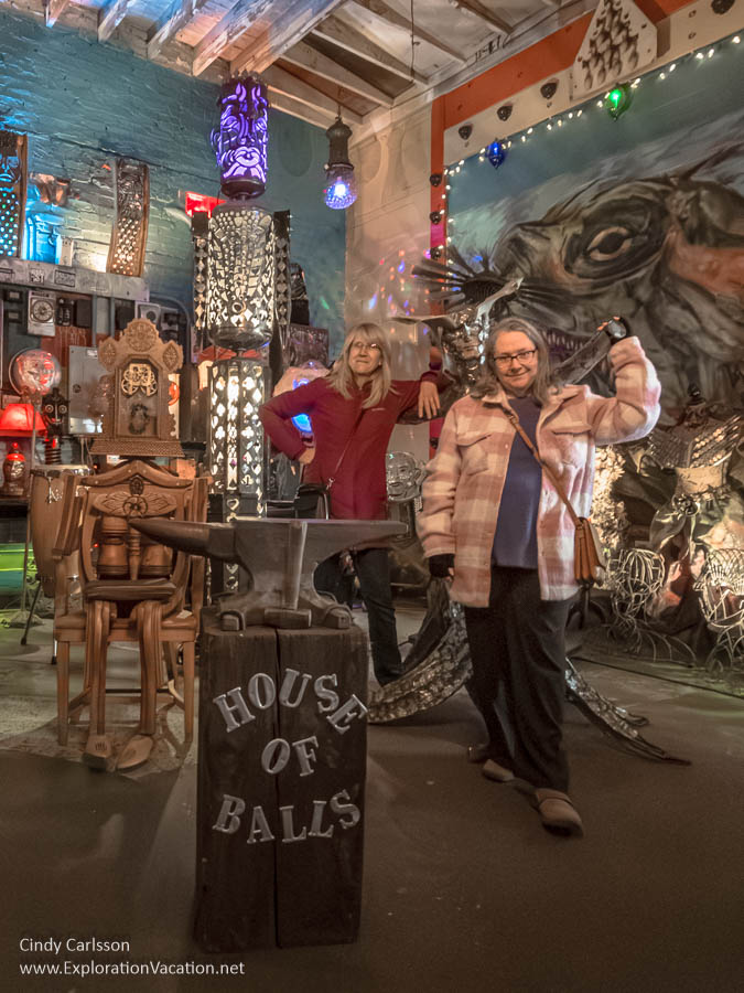 The author and a friend posing with one of the humanoid figures in a gallery at the House of Balls.